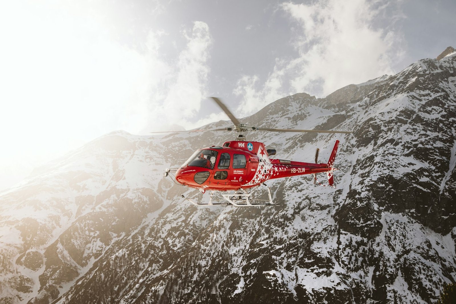 Helicopter flying over a snowy mountain